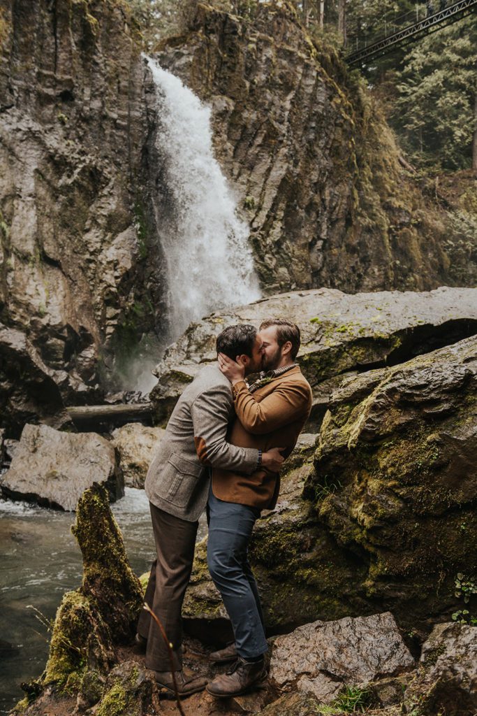 Two men kiss during their elopement. This is the photo they could send to family to announce their elopement.