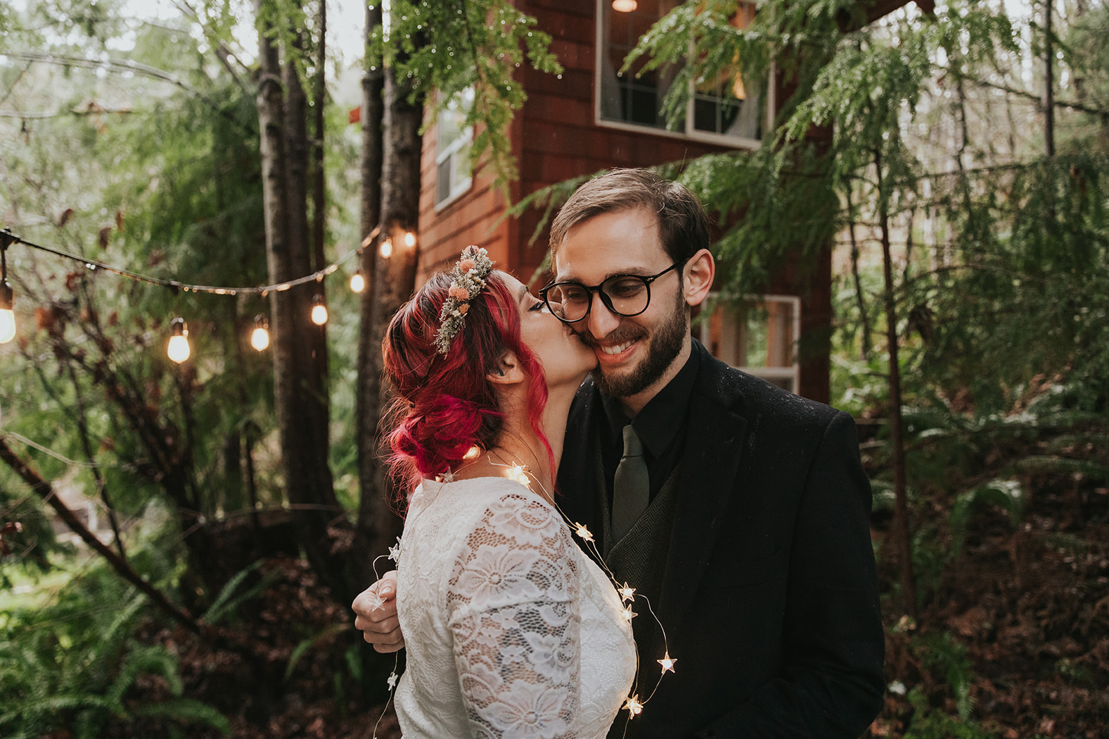 should we elope - a couple smiles in front of a treehouse on their elopement day