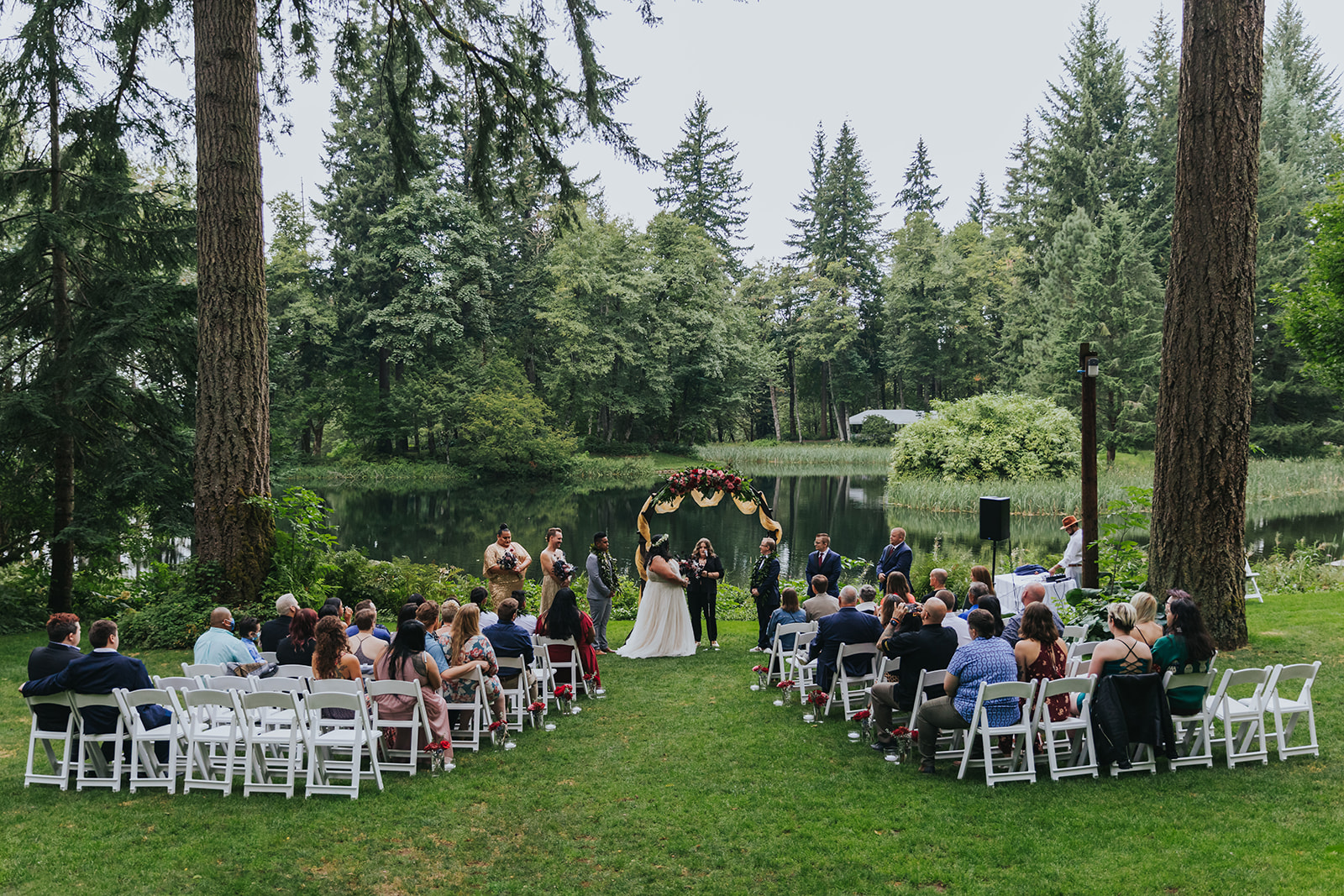 A wedding ceremony in a lakeside forested wedding venue called Bridal Veil Lakes.