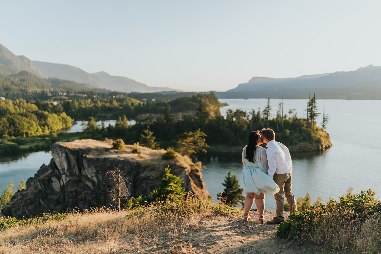 A couple kiss at Government Cove, a popular Oregon engagement photo location.