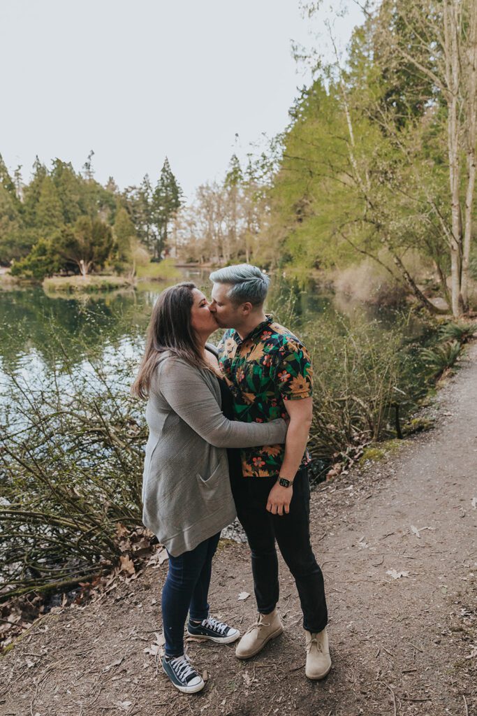 A couple kiss at Laurelhurst Park, a popular Portland engagement photo location.